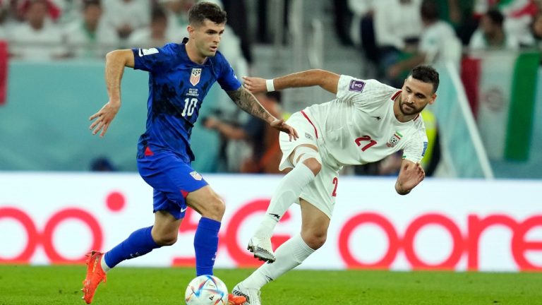 United States' Christian Pulisic (10) controls the ball ahead of Iran's Ahmad Noorollahi (21) during the World Cup match between Iran and the United States at the Al Thumama Stadium in Doha, Qatar, Tuesday, Nov. 29, 2022. (Ashley Landis/AP Photo)