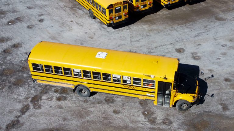 In this stock photo taken using a drone, school buses are seen in a lot in Ottawa on Monday, April 18, 2022. (Sean Kilpatrick/CP)