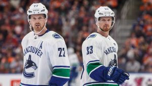 Vancouver Canucks' Daniel Sedin (22) and Henrik Sedin (33) skate past each other against the Edmonton Oilers during first period NHL action in Edmonton, Alta., on Saturday April 7, 2018. (Jason Franson/CP)
