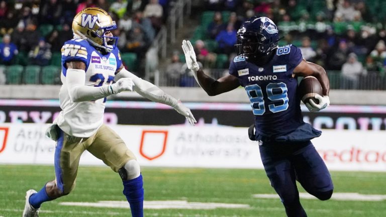 Toronto Argonauts wide receiver Cam Phillips (89) tries to evade a tackle from Winnipeg Blue Bombers defensive back Brandon Alexander (37) during first half football action in the 109th Grey Cup at Mosaic Stadium in Regina, Sunday, Nov. 20, 2022. (Heywood Yu/CP)