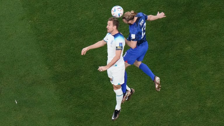 England's Harry Kane, left, and Tim Ream of the United States head the ball during the World Cup group B soccer match between England and The United States, at the Al Bayt Stadium in Al Khor, Qatar, Friday, Nov. 25, 2022. (Hassan Ammar/AP)