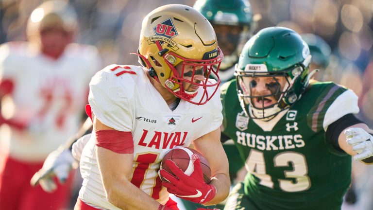 Antoine Dansereau-Leclerc of the Laval Rouge et Or tries to avoid a tackle from Saskatchewan’s Nick Wiebe during the first half of the Vanier Cup against the Huskies in London, Ont., Saturday, Nov. 26, 2022. (Geoff Robins/CP)