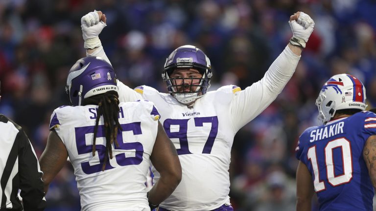Minnesota Vikings defensive tackle Harrison Phillips (97) celebrates with linebacker Za'Darius Smith (55) as the Vikings take the lead over the Buffalo Bills in the second half of an NFL football game, Sunday, Nov. 13, 2022, in Orchard Park, N.Y. (Joshua Bessex/AP)