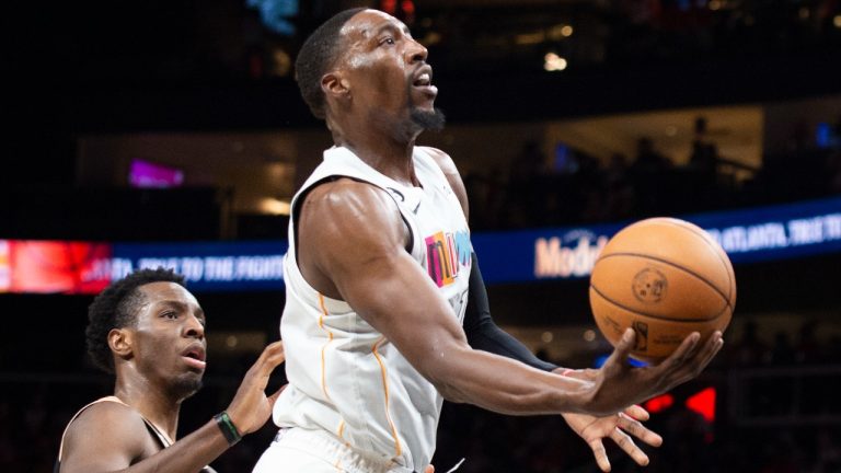 Miami Heat center Bam Adebayo shoots a layup past Atlanta Hawks forward Onyeka Okongwu during the second half of an NBA basketball game, Sunday, Nov. 27, 2022, in Atlanta. (Hakim Wright Sr./AP)
