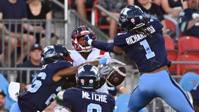 Montreal Alouettes wide receiver Eugene Lewis (87) is surrounded by Toronto Argonauts defensive back Caleb Holden (26), defensive back Royce Metchie (9) as defensive back Shaquille Richardson (1) knocks down a pass attempt during first half CFL football action. (Jon Blacker/CP)
