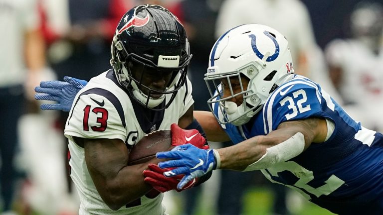 Houston Texans wide receiver Brandin Cooks (13) hauls in a first down catch in front of Indianapolis Colts safety Julian Blackmon (32) during the second half of an NFL football game Sunday, Sept. 11, 2022, in Houston. (David J. Phillip/AP)
