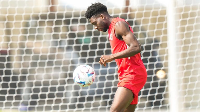 Canada defender Alphonso Davies kicks the ball during practice ahead of the World Cup in Doha, Qatar on Saturday, November 19, 2022. THE CANADIAN PRESS/Nathan Denette