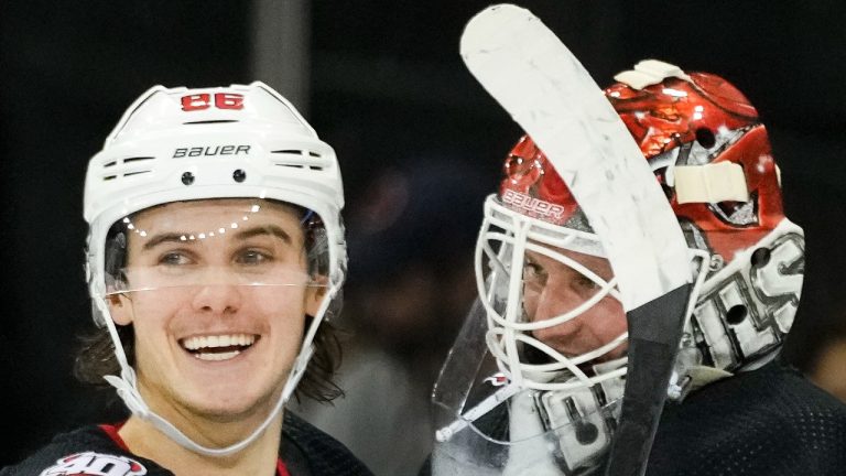 New Jersey Devils center Jack Hughes (86) and goaltender Vitek Vanecek (41) celebrate after closing the third period of an NHL hockey game against the New York Rangers, Monday, Nov. 28, 2022, in New York. (AP Photo/John Minchillo)