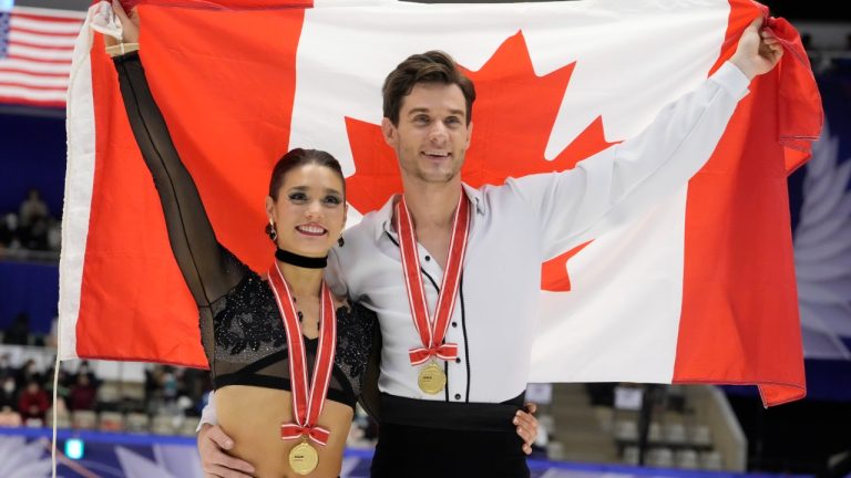 Laurence Fournier Beaudry and Nikolaj Soerensen of Canada pose for a photo celebrating their winning gold in the ice dance free dance program in the Grand Prix of Figure Skating - NHK Trophy in Sapporo, Japan, Saturday, Nov. 19, 2022. (Hiro Komae/AP)