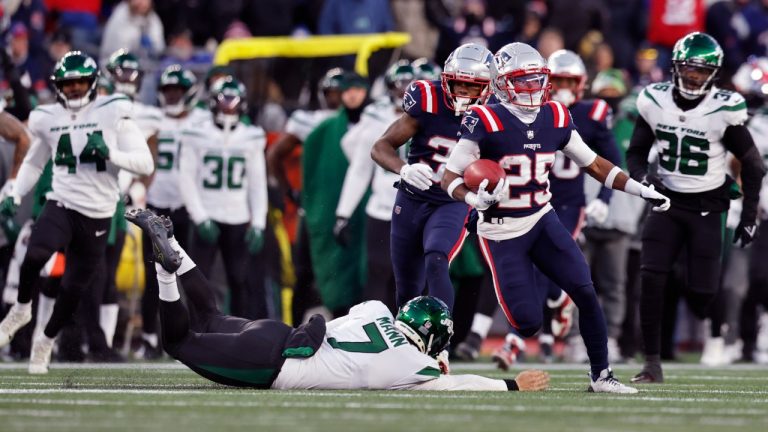 New England Patriots cornerback Marcus Jones (25) runs past New York Jets punter Braden Mann, left, on his punt return for a touchdown during the second half of an NFL football game, Sunday, Nov. 20, 2022, in Foxborough, Mass. The Patriots won 10-3.(Michael Dwyer/AP)