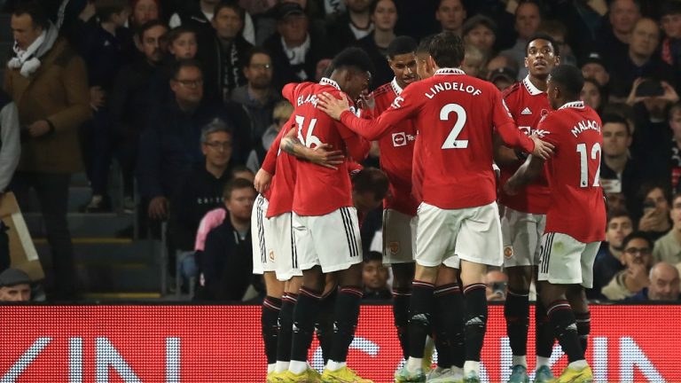 Manchester United's Christian Eriksen celebrates with teammates after scoring his side's opening goal during the English Premier League soccer match between Fulham and Manchester United at the Craven Cottage stadium in London, Sunday, Nov. 13, 2022. (AP Photo/Leila Coker)