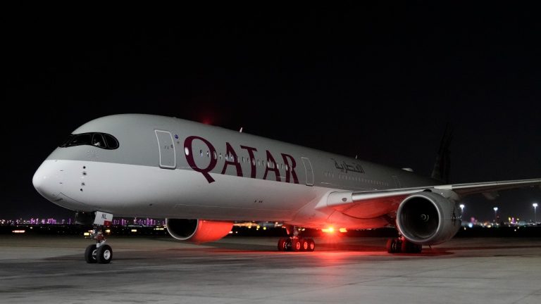 A Qatar Airways aircraft lands with members of the United States national soccer team at Hamad International airport in Doha, Qatar, Thursday, Nov. 10, 2022 ahead of the upcoming World Cup. The US will play their first match in the World Cup against Wales on Nov. 21. (AP Photo/Hassan Ammar)
