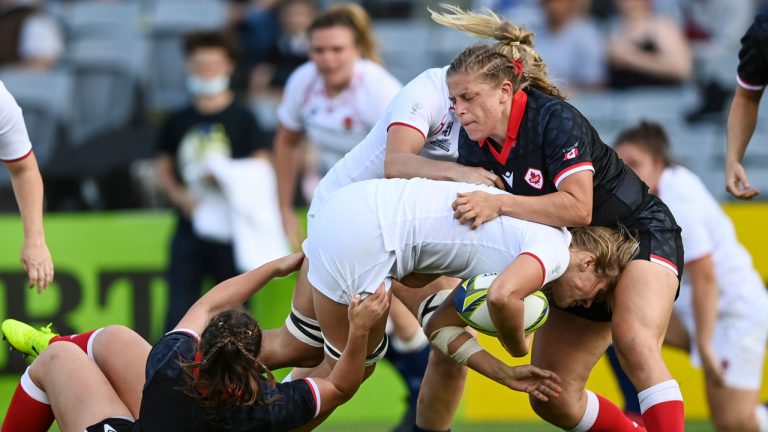 Zoe Aldcroft of England is tackled by DaLeaka Menin of Canada during the women's rugby World Cup semifinal between Canada and England at Eden Park. (Andrew Cornaga/AP)