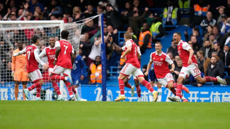 Arsenal's Bukayo Saka, third from left back to the camera, celebrates with teammates after their opening goal during the English Premier League soccer match between Chelsea and Arsenal at Stamford Bridge Stadium in London, Sunday, Nov. 6, 2022. (Kirsty Wigglesworth/AP)