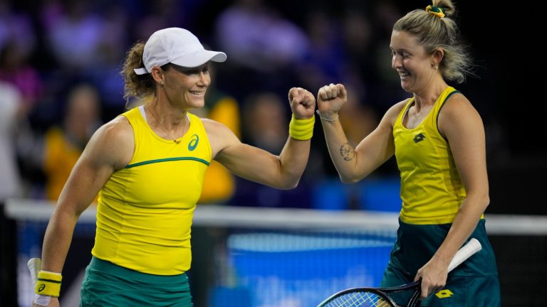 Storm Sanders, right, and Samantha Stosur of Australia gesture as they play Alicia Barnett and Olivia Nicholls of Britain, during the semi-finals match, of the Billie Jean King Cup tennis tournament, at the Emirates Arena in Glasgow, Scotland, Saturday, Nov. 12, 2022. (Kin Cheung/AP)
