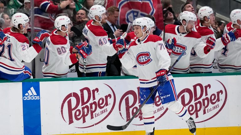 Montreal Canadiens center Jake Evans (71) celebrates with the bench after scoring against the Dallas Stars in the first period of an NHL hockey game, Friday, Dec. 23, 2022, in Dallas. (AP Photo/Tony Gutierrez)