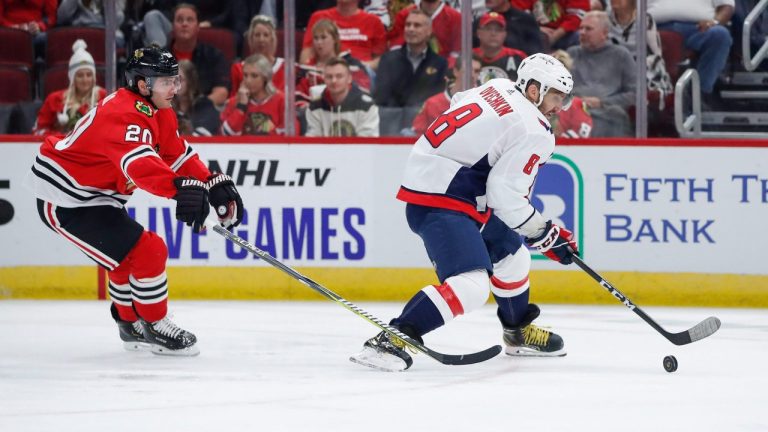 Washington Capitals left wing Alex Ovechkin (8) controls the puck in front of Chicago Blackhawks left wing Brandon Saad (20) during the first period of a preseason NHL hockey game. (Kamil Krzaczynski/AP)