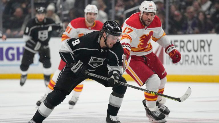 Los Angeles Kings right wing Adrian Kempe (9) controls the puck against Calgary Flames left wing Milan Lucic (17) during the second period of an NHL hockey game Thursday, Dec. 22, 2022, in Los Angeles. (Ashley Landis/AP)
