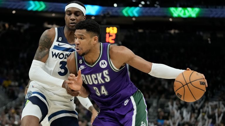 Milwaukee Bucks' Giannis Antetokounmpo tries to drive past Minnesota Timberwolves' Jaden McDaniels during the second half of an NBA basketball game Friday, Dec. 30, 2022, in Milwaukee. The Bucks won 123-114. (Morry Gash/AP)