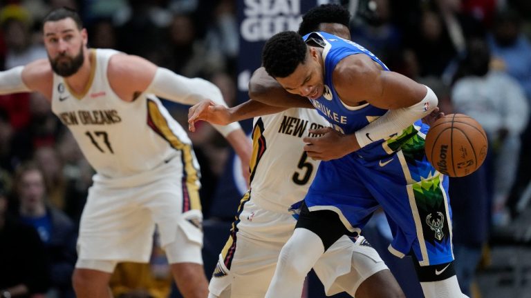 Milwaukee Bucks forward Giannis Antetokounmpo loses the ball against New Orleans Pelicans forward Herbert Jones in the second half of an NBA basketball game in New Orleans, Monday, Dec. 19, 2022. The Bucks won 128-119. (Gerald Herbert/AP Photo)