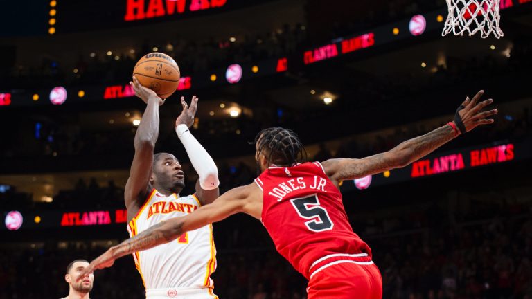 Atlanta Hawks forward AJ Griffin, front left, shoots a buzzer-beater over Chicago Bulls forward Derrick Jones Jr. during the second half of an NBA basketball game, Sunday, Dec. 11, 2022, in Atlanta. (Hakim Wright Sr./AP)