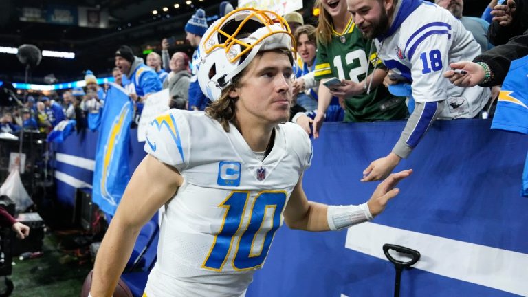 Los Angeles Chargers quarterback Justin Herbert greets fans as he leaves the field following an NFL football game against the Indianapolis Colts, Monday, Dec. 26, 2022, in Indianapolis. (Michael Conroy/AP Photo)