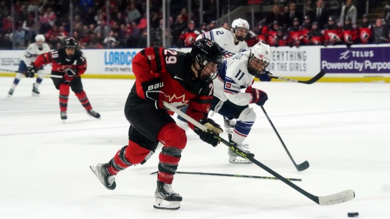 Canada's Marie-Philip Poulin (29) skates past United States' Abby Roque (11) during overtime Rivalry Series hockey action in Kelowna, B.C., Tuesday, Nov. 15, 2022. Jesse Johnston/THE CANADIAN PRESS