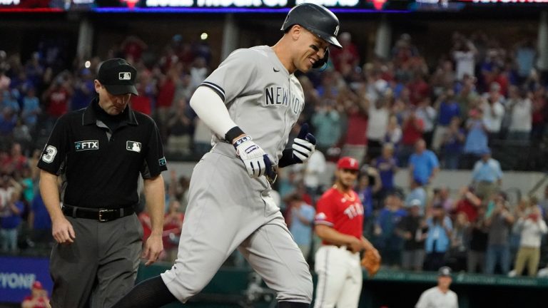 New York Yankees' Aaron Judge runs out his solo home run, his 62nd of the season, as Texas Rangers starting pitcher Jesus Tinoco looks on in the background during the first inning in the second baseball game in Arlington, Texas, Oct. 4, 2022 (LM Otero/AP Photo)