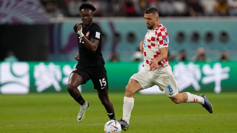 Croatia's Mateo Kovacic, right, runs with the ball past Canada's Ismael Kone during the World Cup group F soccer match between Croatia and Canada, at the Khalifa International Stadium in Doha, Qatar, Sunday, Nov. 27, 2022. (Thanassis Stavrakis/AP)