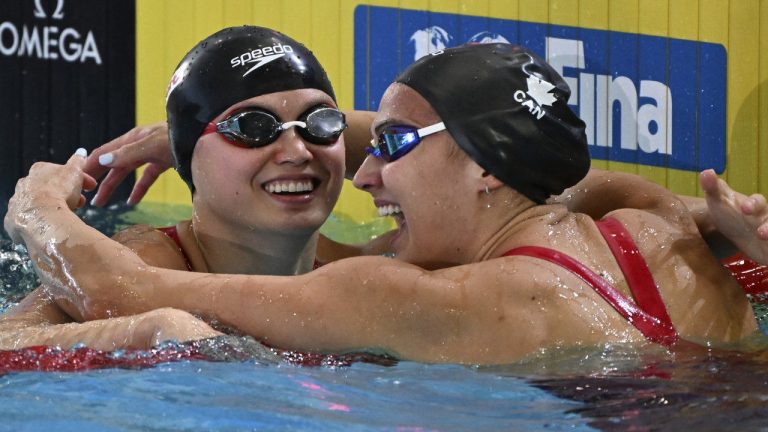 Maggie Mac Neil of Canada, left, is congratulated by teammate Kylie Masse after Mac Neil won the women's 50m backstroke final during the world swimming short course championships in Melbourne, Australia, Friday, Dec. 16, 2022. (Asanka Brendon Ratnayake/AP)