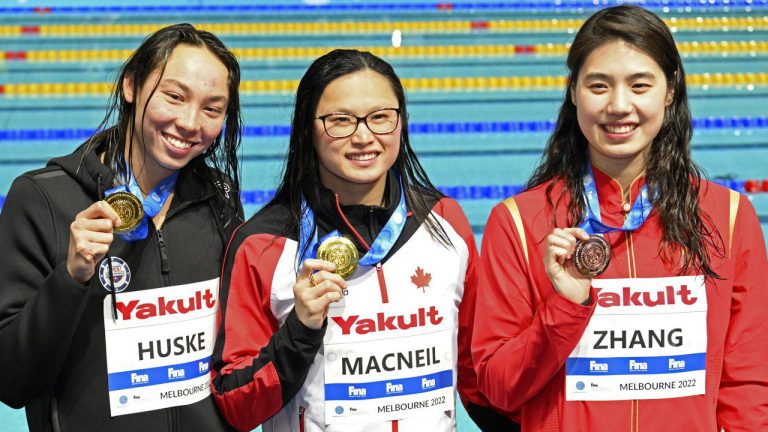 Maggie Mac Neil of Canada, centre, Torri Huske of the U.S., left, and Yufei Zhang of China pose with their medals from the women's 50m butterfly final during the world swimming short course championships in Melbourne, Australia, Wednesday, Dec. 14, 2022. (Asanka Brendon Ratnayake/AP)