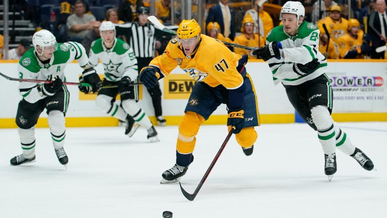 Nashville Predators right wing Michael McCarron (47) and Dallas Stars left wing Roope Hintz (24) race after the puck in the second period of an NHL hockey game Thursday, Feb. 24, 2022, in Nashville, Tenn. (Mark Humphrey/AP)