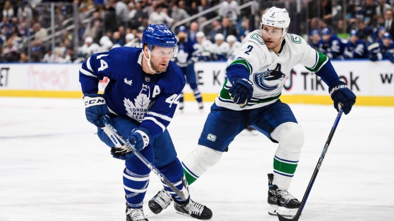 Toronto Maple Leafs defenceman Morgan Rielly (44) is defended by Vancouver Canucks defenceman Luke Schenn (2) during second period NHL hockey action, in Toronto on Saturday, Nov. 12, 2022. Christopher Katsarov/THE CANADIAN PRESS