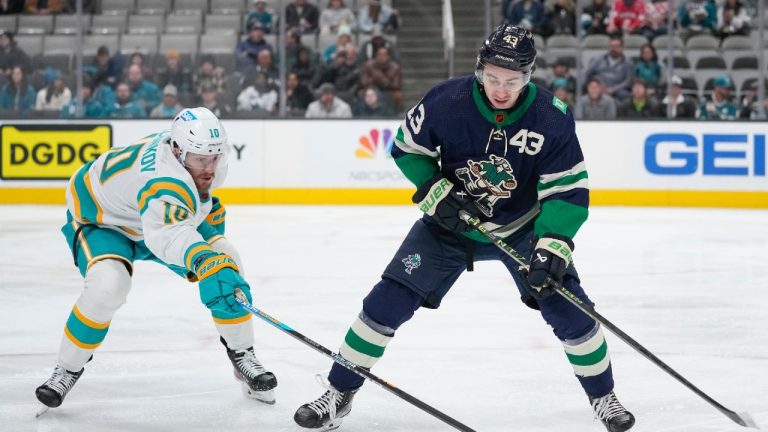San Jose Sharks left wing Evgeny Svechnikov, left, and Vancouver Canucks defenseman Quinn Hughes chase the puck during the first period of an NHL hockey game in San Jose, Calif., Wednesday, Dec. 7, 2022. (Godofredo A. Vasquez/AP)
