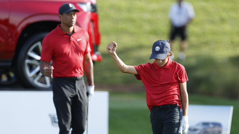 Charlie Woods reacts on the 17th tee as father Tiger Woods watches during the second round of the PNC Championship golf tournament Sunday, Dec. 19, 2021, in Orlando, Fla. (Scott Audette/AP)