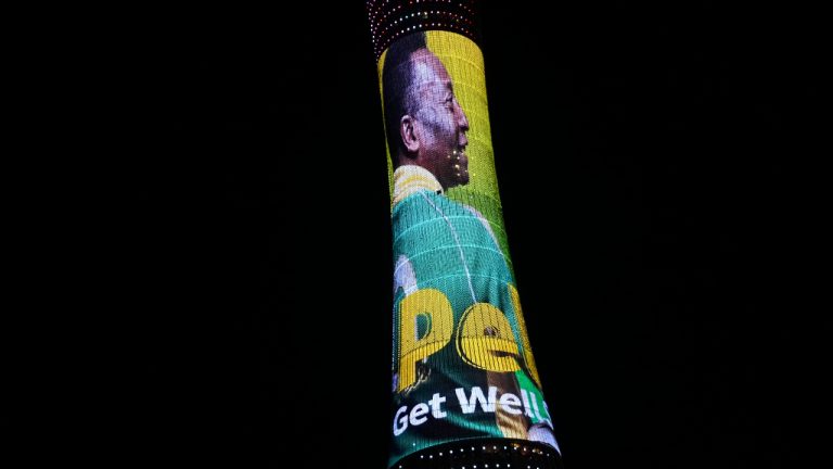 An image of former Brazilian player Pele with the message "Pele, Get well soon" is displayed on the Torch tower outside the Khalifa International Stadium in Doha, Qatar, Saturday, Dec. 3, 2022. Pele was hospitalized in Sao Paulo to regulate the medication in his fight against a colon tumor, his daughter said on Wednesday, Nov. 30, 2022. (Luca Bruno/AP)