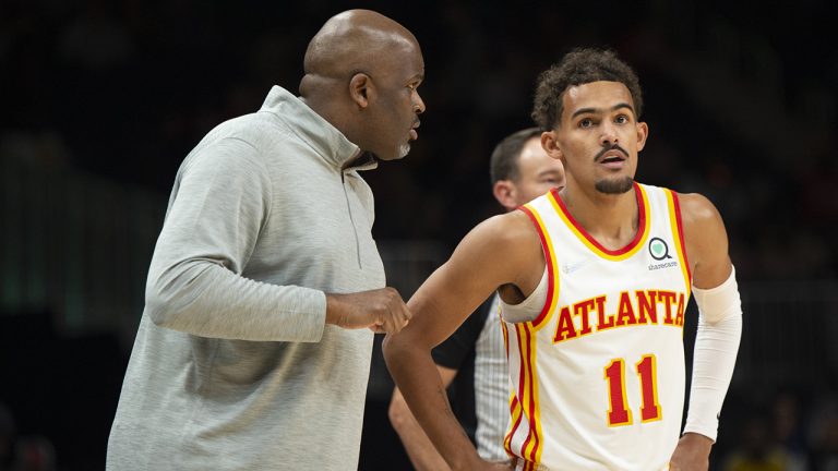 Atlanta Hawks head coach Nate McMillan, left, talks with guard Trae Young (11) during the first half of an NBA basketball game against the Detroit Pistons, Monday, Oct. 25, 2021, in Atlanta. (Hakim Wright Sr./AP)