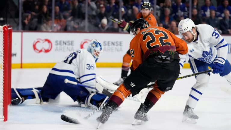 Arizona Coyotes center Jack McBain (22) beats Toronto Maple Leafs goaltender Matt Murray (30) and defenseman Timothy Liljegren (37) for a goal during the third period of an NHL hockey game in Tempe, Ariz., Thursday, Dec. 29, 2022. The Coyotes won 6-3. (Ross D. Franklin/AP)