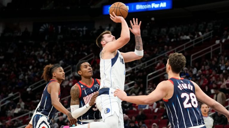 Dallas Mavericks guard Luka Doncic, center top, shoots over Houston Rockets center Alperen Sengun (28) during the first half of an NBA basketball game, Friday, Dec. 23, 2022, in Houston. (Eric Christian Smith/AP)