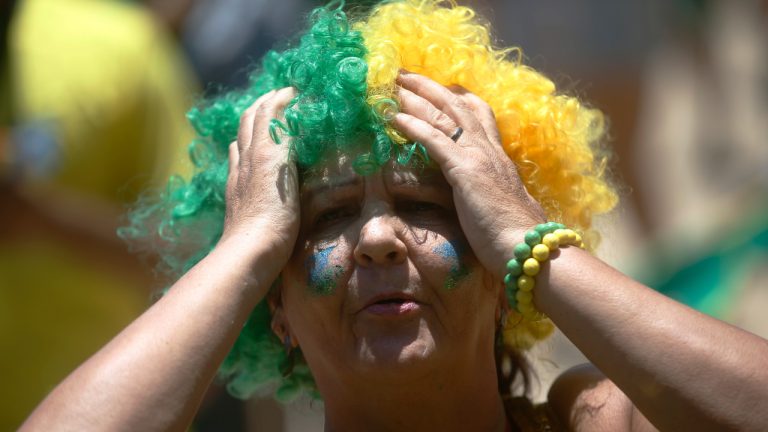 A Brazil soccer fans watches the team's World Cup match against Croatia, during the quarterfinals of the World Cup tournament hosted by Qatar, on a screen set up at the FIFA Fan Fest Arena on Copacabana beach in Rio de Janeiro, Brazil, Friday, Dec. 9, 2022. (Bruna Prado/AP)