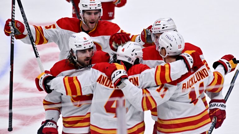 Calgary Flames defenseman Rasmus Andersson (4) celebrates with teammates after scoring against the Anaheim Ducks during overtime in an NHL hockey game in Anaheim, Calif., Friday, Dec. 23, 2022. (Alex Gallardo/AP)