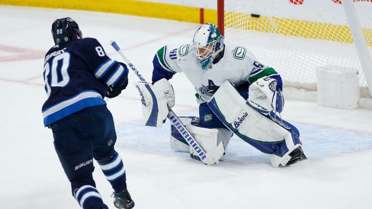 Winnipeg Jets' Pierre-Luc Dubois (80) scores on a penalty shot against Vancouver Canucks goaltender Collin Delia (60) during second period NHL action in Winnipeg, Thursday, December 29, 2022. (John Woods/CP)