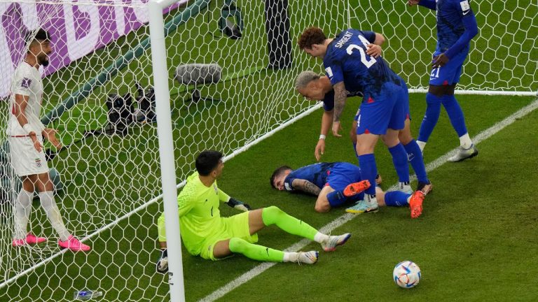 Christian Pulisic of the United States lays injured on the pitch after he scoring his side's opening goal during the World Cup group B soccer match between Iran and the United States at the Al Thumama Stadium in Doha, Qatar, Tuesday, Nov. 29, 2022. (Luca Bruno/AP)