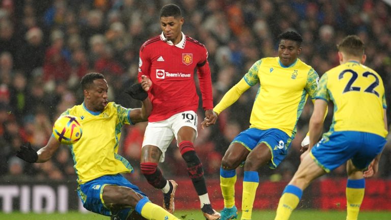 Nottingham Forest's Willy Boly, left, challenges for the ball with Manchester United's Marcus Rashford during the English Premier League soccer match between Manchester United and Nottingham Forest at Old Trafford in Manchester, England, Tuesday, Dec. 27, 2022. (Dave Thompson/AP)