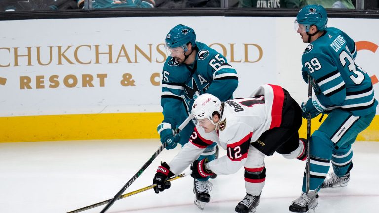 San Jose Sharks defenseman Erik Karlsson (65) and Ottawa Senators right wing Alex DeBrincat (12) compete for possession of the puck during the third period of an NHL hockey game. (Godofredo A. Vasquez/AP)