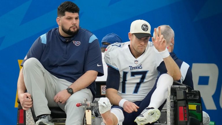 Tennessee Titans quarterback Ryan Tannehill, right, gestures while being carted off the field during the first half of an NFL football game against the Los Angeles Chargers in Inglewood, Calif., Sunday, Dec. 18, 2022. (AP Photo/Ashley Landis)