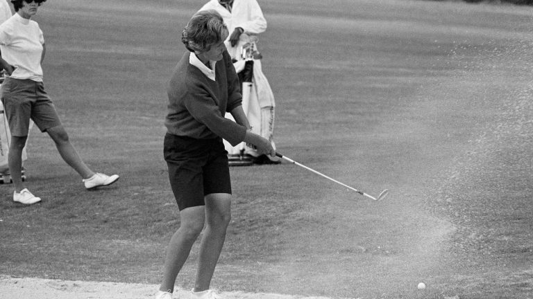 FILE - Kathy Whitworth of San Antonio, blast out of sand trap on 18th green and then sinks a 6-foot putt to go into the lead of the Women Titleholders Golf Tournament at Augusta, Ga., Nov. 25, 1966. Former LPGA Tour player Whitworth, whose 88 victories are the most by any golfer on a single professional tour, died on Saturday, Dec. 25, 2022, night, her longtime partner said. She was 83. (Horace Cort, AP Photo File)