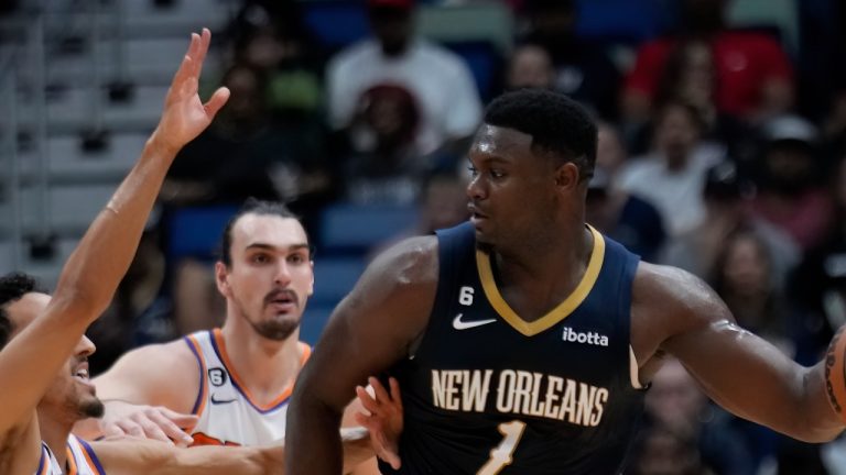 New Orleans Pelicans forward Zion Williamson (1) looks to pass around Phoenix Suns guard Landry Shamet (14) in the first half of an NBA basketball game in New Orleans, Sunday, Dec. 11, 2022. (AP Photo/Gerald Herbert)