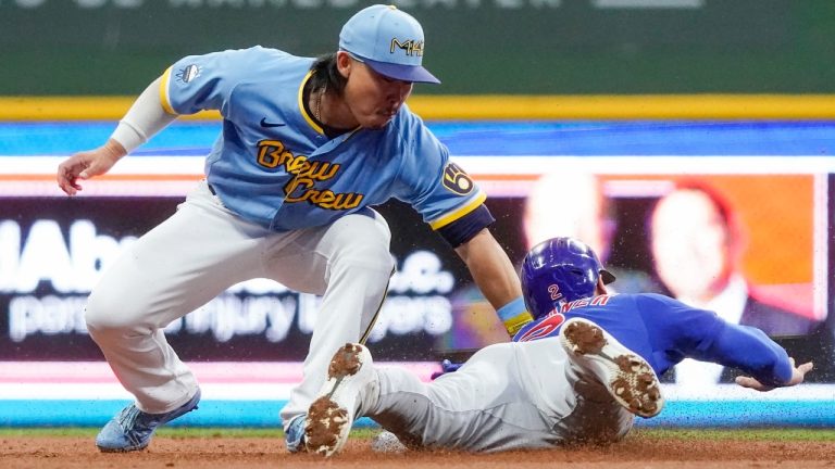 Milwaukee Brewers' Keston Hiura tags out Chicago Cubs' Nico Hoerner as he is caught stealing second during the second inning of a baseball game Friday, Aug. 26, 2022, in Milwaukee. (Morry Gash/AP Photo)