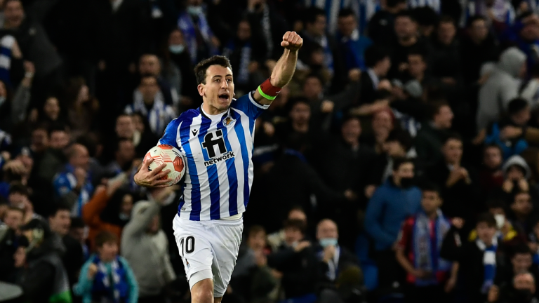 Real Sociedad's Mikel Oyarzabal celebrates after his teammate Real Sociedad's Martin Zubimendi scores his side's opening goal during the Europa League Play-off, second leg, soccer match between Real Sociedad and Leipzig at the Reale Arena stadium in San Sebastian, Spain, Thursday, Feb. 24, 2022. (AP)